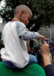 Child and parent enjoying Mardi Grass 2015 in New Orleans